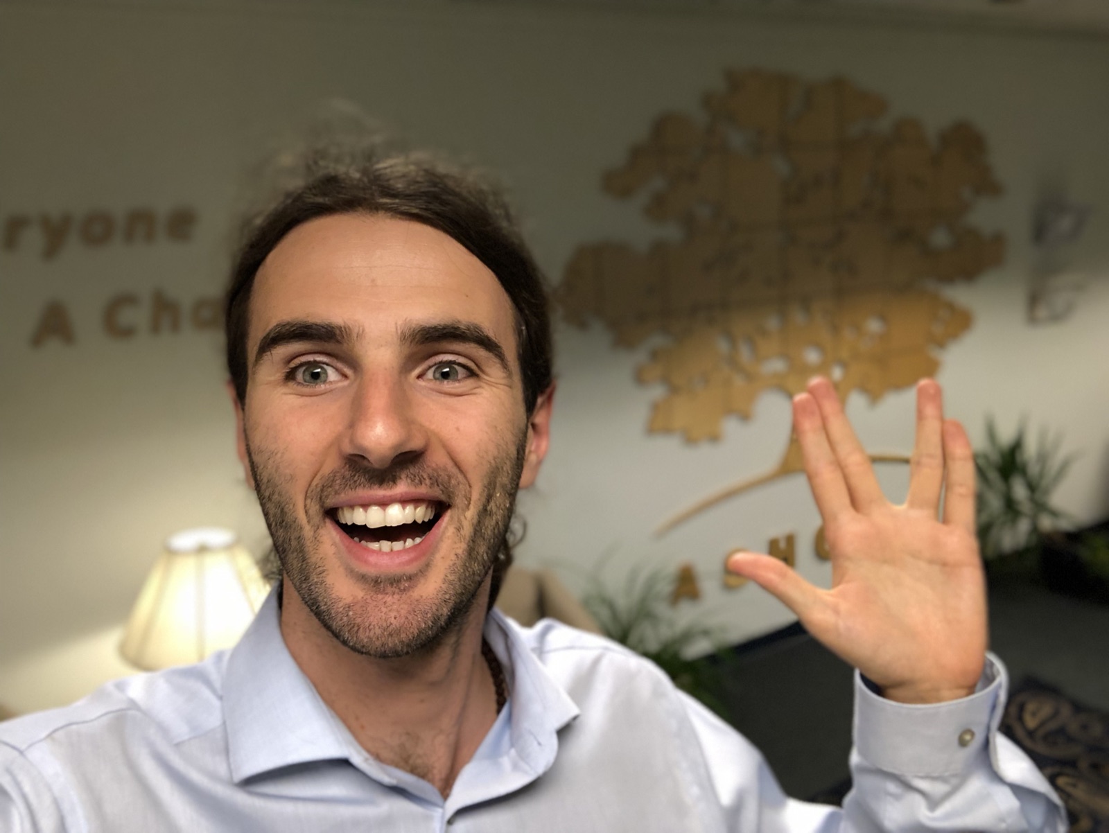 Mentor Dida smiling and waving during his time at Ashoka.