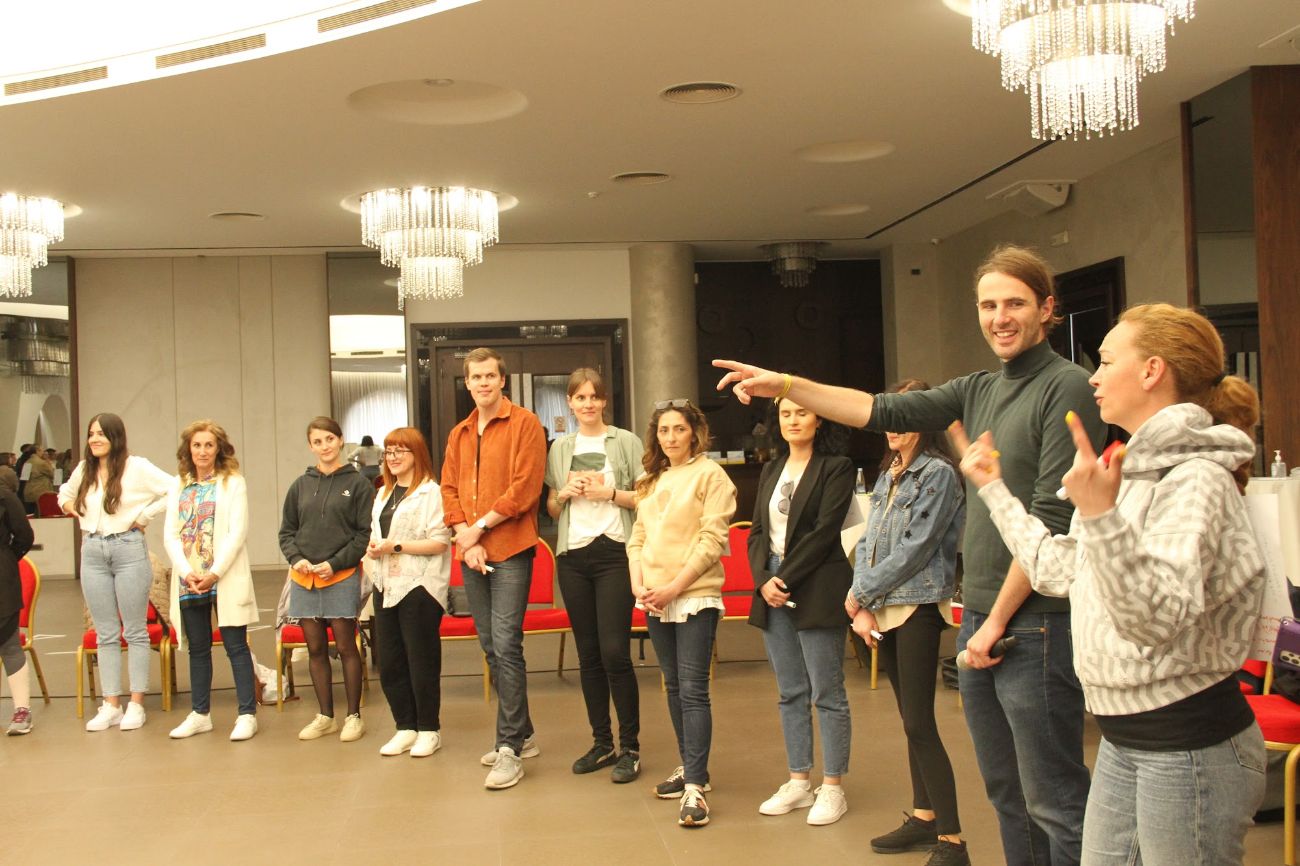 Mentor Dida facilitating a workshop with a standing group of participants